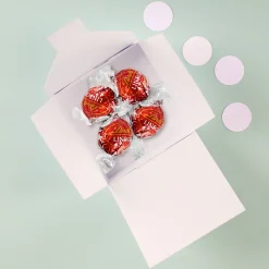 Frohe Ostern Geschenk - 4 Lindorkugeln in pastellfarbener Osterverpackung