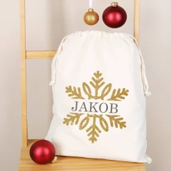 Geschenksack zu Weihnachten mit Schneeflocke in Goldoptik und Name bedruckt