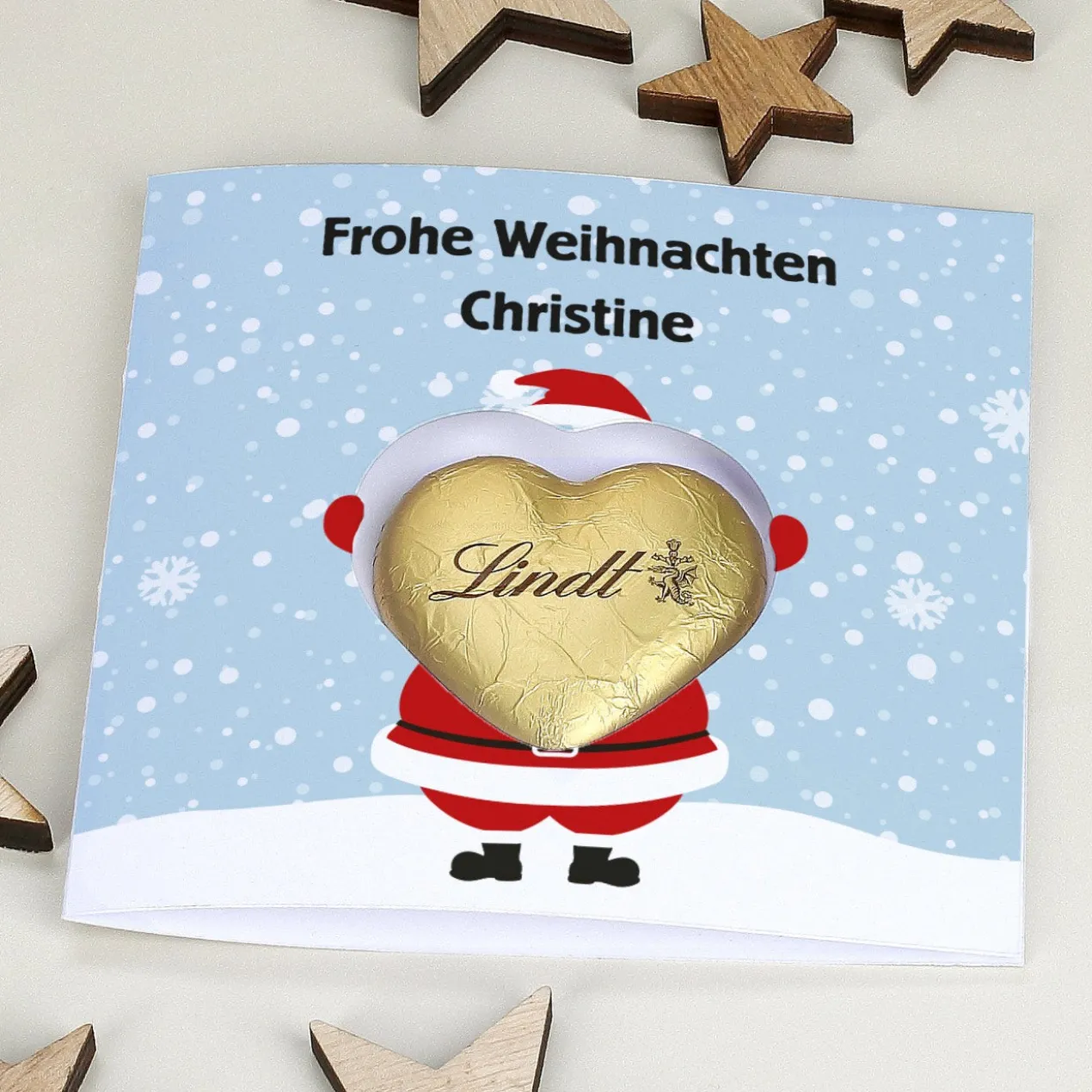 Karte mit Weihnachtsdruck und Lindt Schokoherz