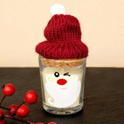 Kerze im Glas mit Korken und Pudelmütze im Santa-Design