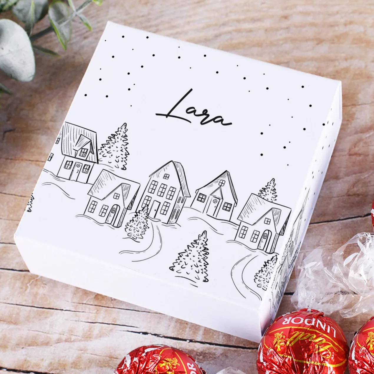 Persönliche Geschenkverpackung und 4 Lindor Kugeln mit verschneiter Stadt als Motiv