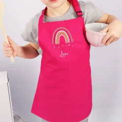 Rosafarbene Kinderschürze mit Regenbogenmotiv und Name